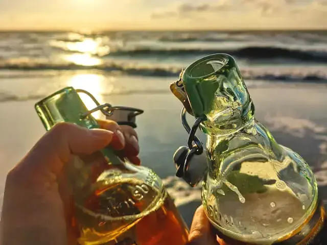 Es wird mit zwei Flaschen Flensburger Gold vorm Sonnenuntergang am Strand angestoßen.