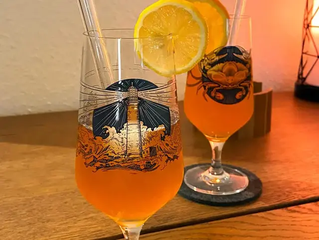 Zwei Gläser mit dem Spaghett-Cocktail aus FLENS Edles Helles, Aperol und Zitronensaft.